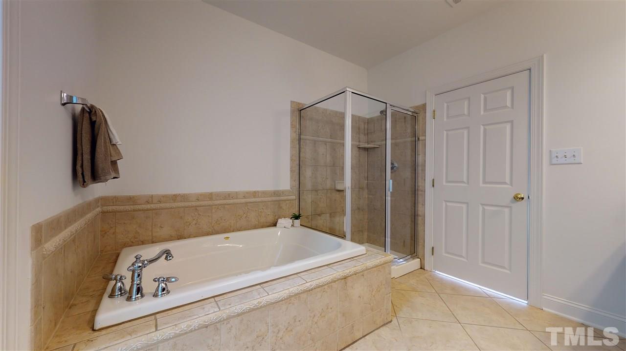 11245 Maplecroft Court Raleigh, NC 27617 - Photo 12 of 30 Generous 1st Floor Master Suite w/ luxurious garden tub, dual vanity, glass/tile shower, & oversized WIC.