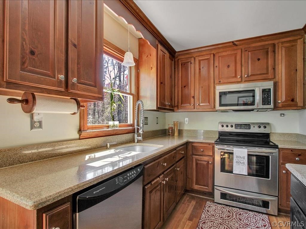 5603 Sandstone Ridge Road Midlothian, VA 23112 - Photo 12 of 39 a kitchen with stainless steel appliances granite countertop a stove a sink and a microwave