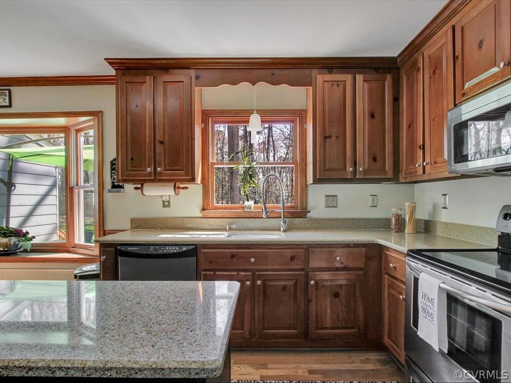 5603 Sandstone Ridge Road Midlothian, VA 23112 - Photo 13 of 39 a kitchen with stainless steel appliances granite countertop a stove a sink and a microwave