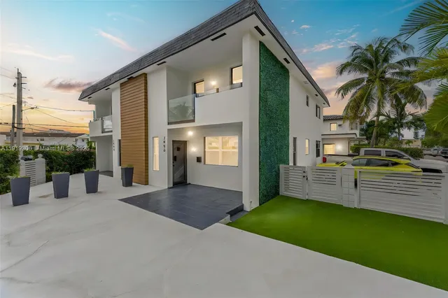 a view of a house with a patio and a yard