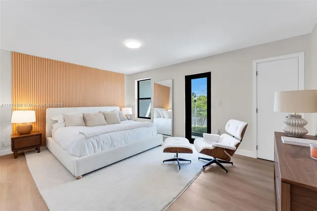 a living room with furniture and a potted plant on table