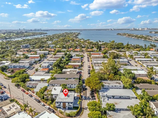 an aerial view of residential building and car parked on street side