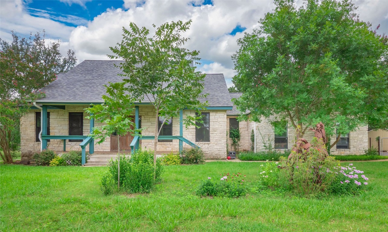 13503-13511 Carpenter Lane Manchaca, TX 78652 - Photo 19 of 40 a front view of a house with a garden and plants