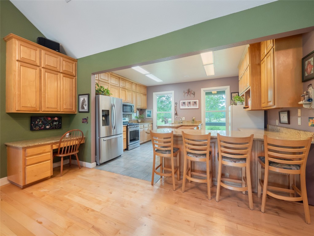 13503-13511 Carpenter Lane Manchaca, TX 78652 - Photo 23 of 40 a kitchen with a table chairs refrigerator and cabinets
