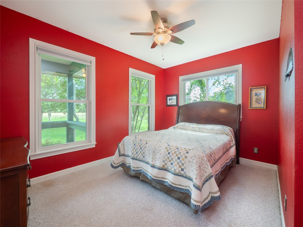 13503-13511 Carpenter Lane Manchaca, TX 78652 - Photo 27 of 40 a bed sitting in a bedroom next to a window
