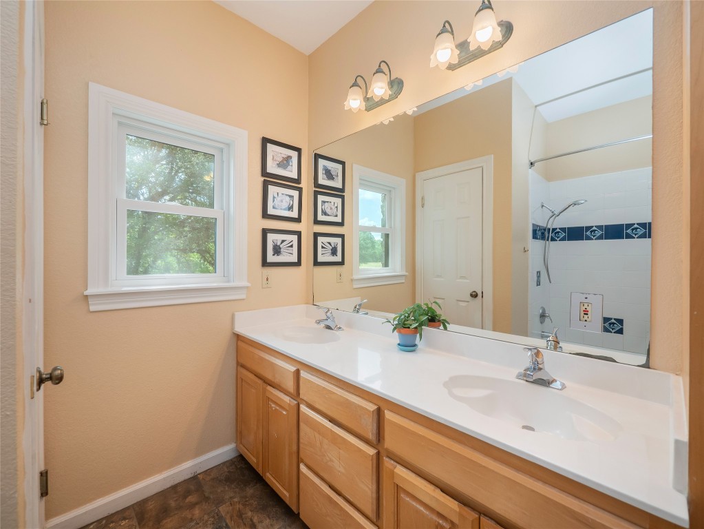 13503-13511 Carpenter Lane Manchaca, TX 78652 - Photo 28 of 40 a bathroom with a sink and a mirror