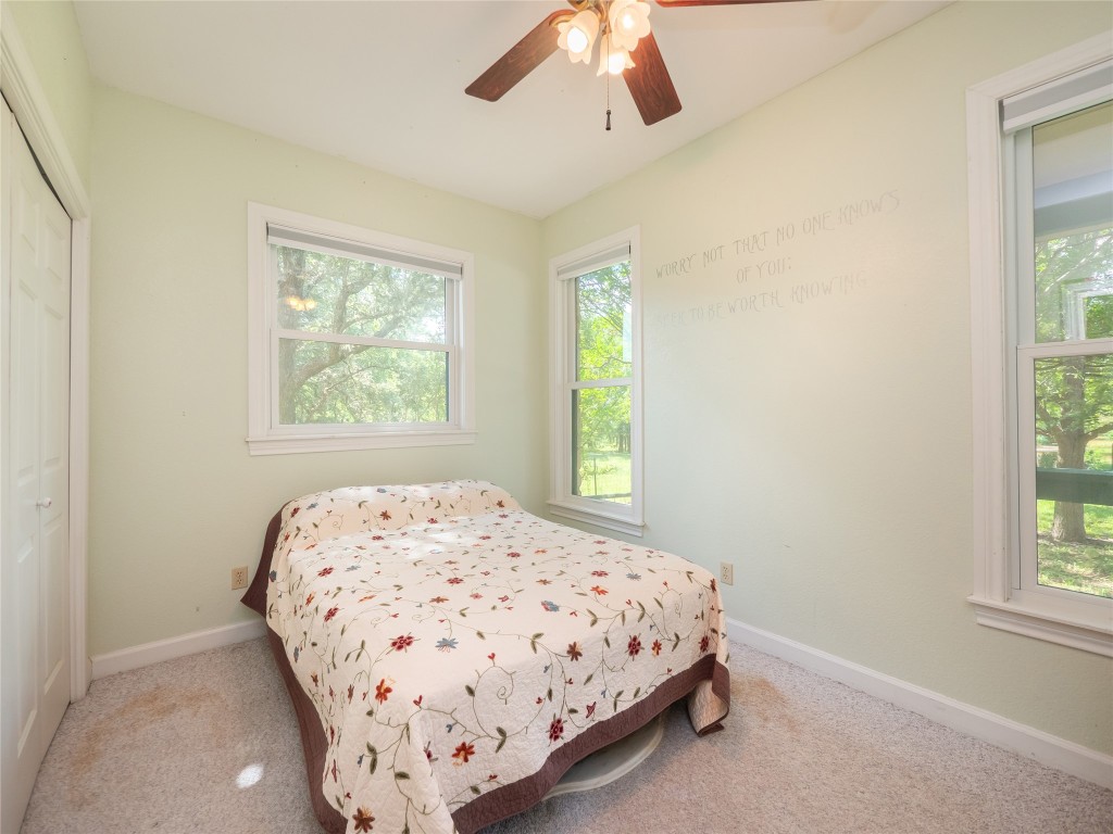 13503-13511 Carpenter Lane Manchaca, TX 78652 - Photo 29 of 40 a bedroom with a bed and a window