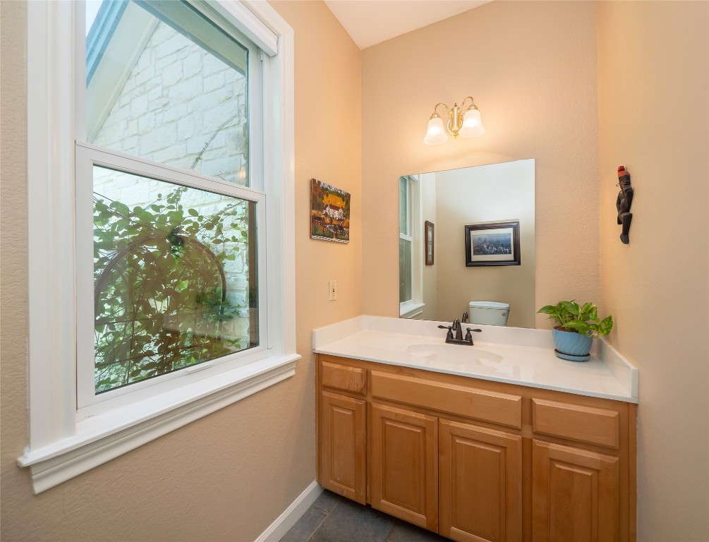 13503-13511 Carpenter Lane Manchaca, TX 78652 - Photo 30 of 40 a bathroom with a granite countertop sink mirror and window