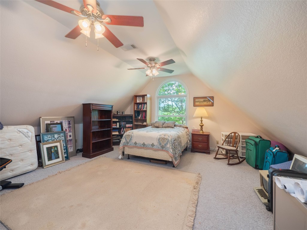 13503-13511 Carpenter Lane Manchaca, TX 78652 - Photo 31 of 40 a bedroom with a bed furniture and a chandelier