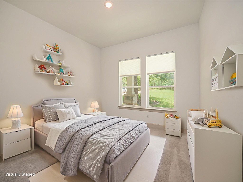 13503-13511 Carpenter Lane Manchaca, TX 78652 - Photo 9 of 40 a bedroom with a bed and a window