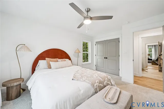 a bedroom with a bed and a large mirror