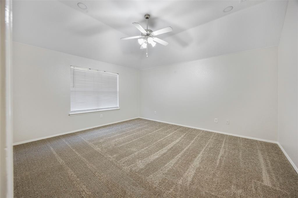 3603 Cottonwood Road Melissa, TX 75454 - Photo 13 of 22 Spare room with carpet flooring, vaulted ceiling, and ceiling fan