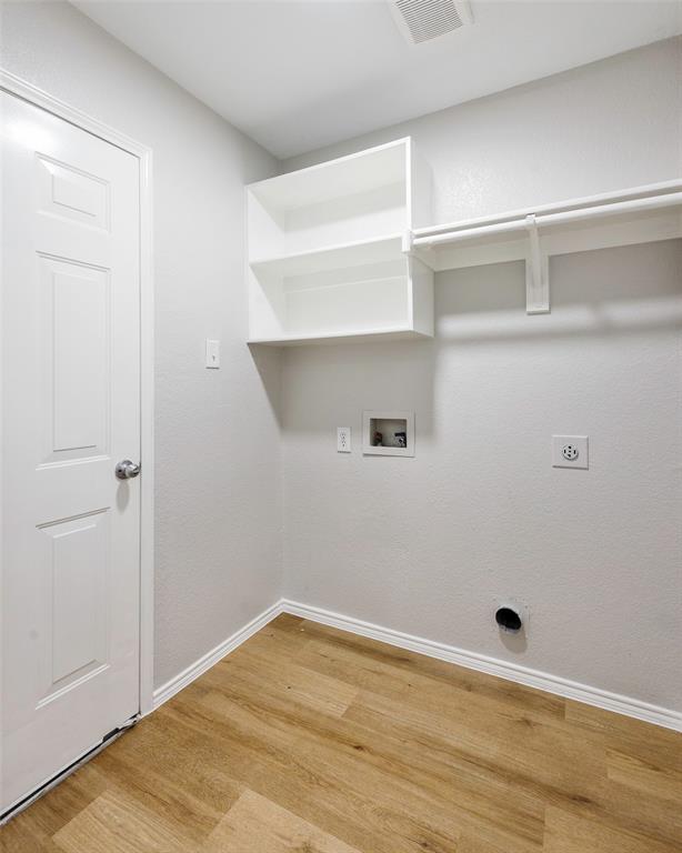 3603 Cottonwood Road Melissa, TX 75454 - Photo 19 of 22 Washroom featuring light wood-type flooring, washer hookup, and electric dryer hookup