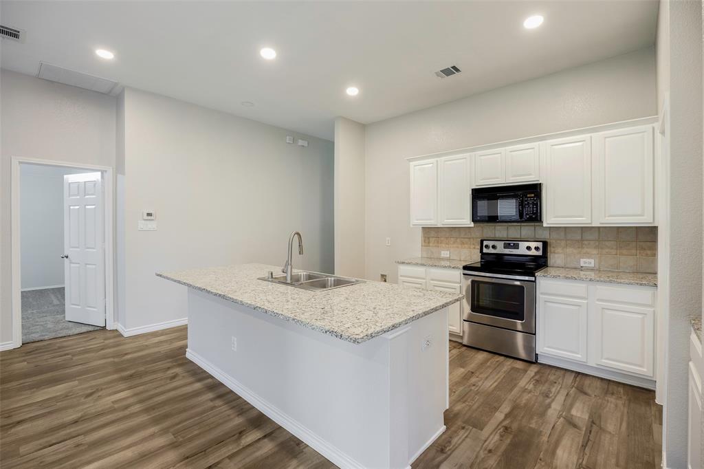 3603 Cottonwood Road Melissa, TX 75454 - Photo 6 of 22 Kitchen featuring decorative backsplash, stainless steel electric range oven, white cabinets, black microwave, and recessed lighting