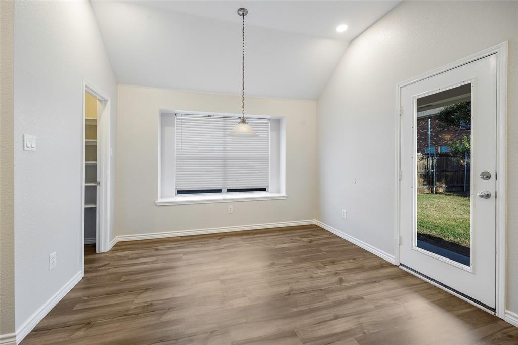 3603 Cottonwood Road Melissa, TX 75454 - Photo 8 of 22 Unfurnished dining area featuring wood finished floors, vaulted ceiling, and recessed lighting