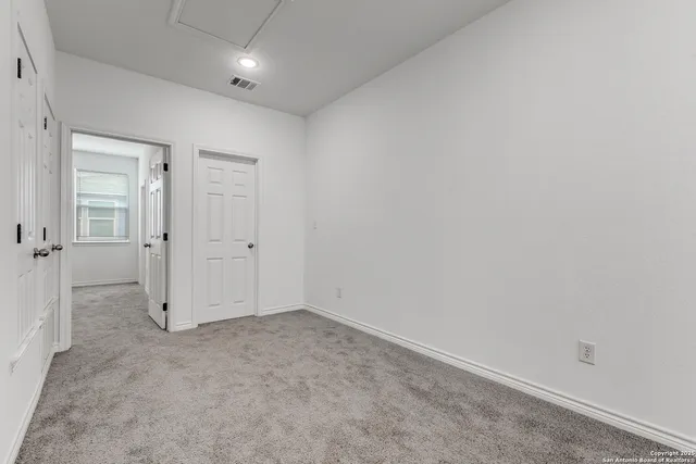 an empty room with closet area