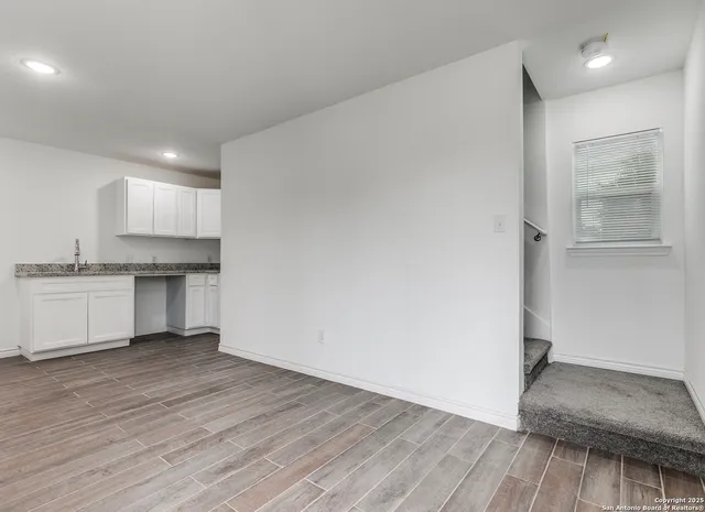 a view of kitchen with wooden floor and electronic appliances