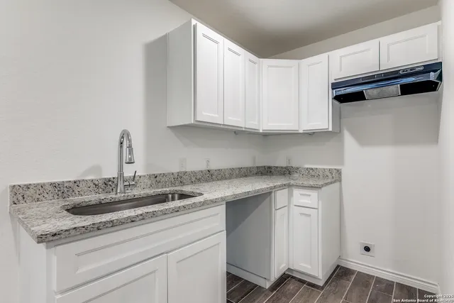a kitchen with a sink and cabinets