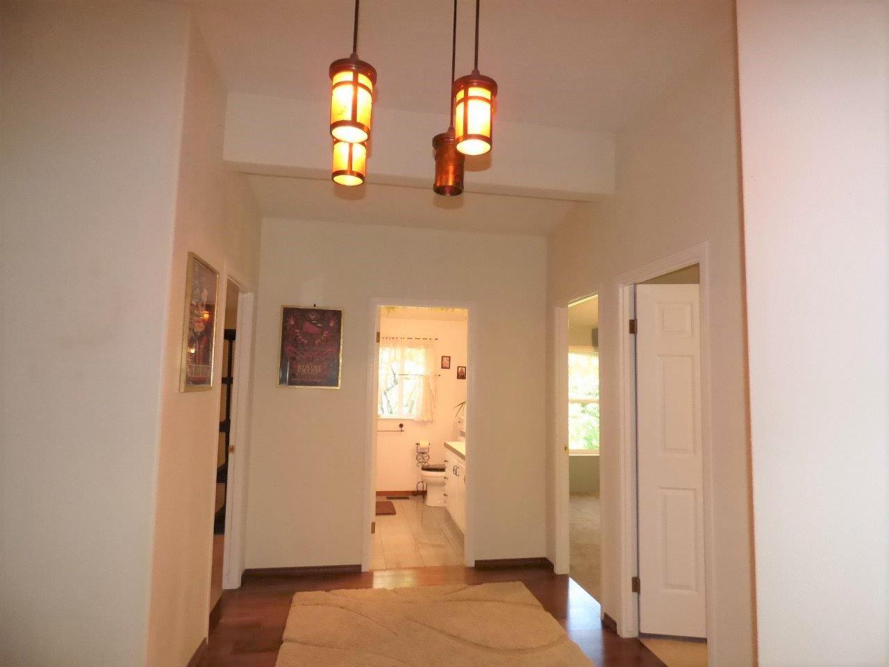 6520 Tunnel Loop Road Grants Pass, OR 97526 - Photo 28 of 69 a view of a hallway with wooden floor and a bathroom