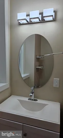 a bathroom with a sink and mirror