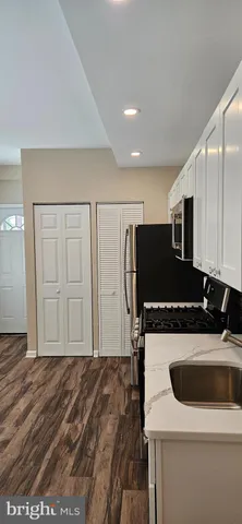 a kitchen with a stove a microwave and a refrigerator