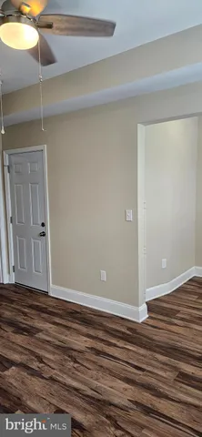 a view of room with wooden floor