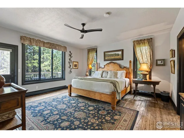 a bathroom with a double vanity sink toilet mirror and a window