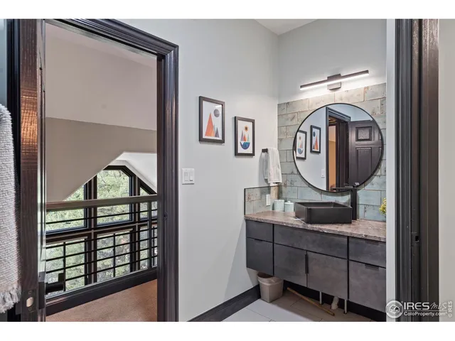 a bathroom with a granite countertop sink a mirror and shower