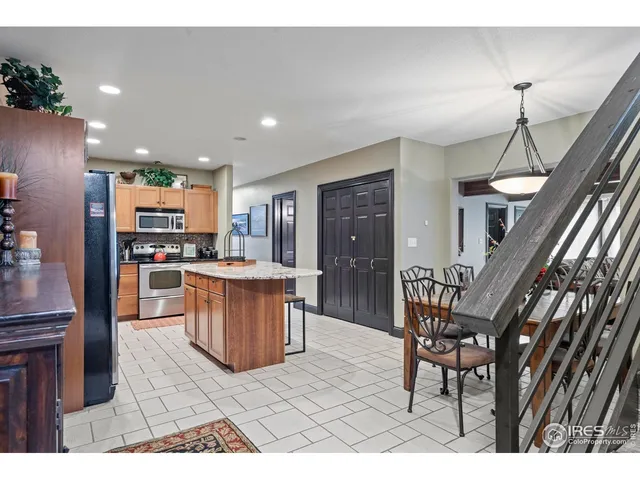 a kitchen with stainless steel appliances kitchen island granite countertop a sink and cabinets