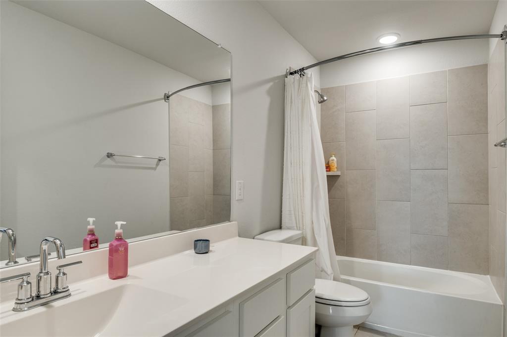 8413 Alba Lane Rowlett, TX 75089 - Photo 17 of 25 Bathroom with vanity and shower / bathtub combination with curtain