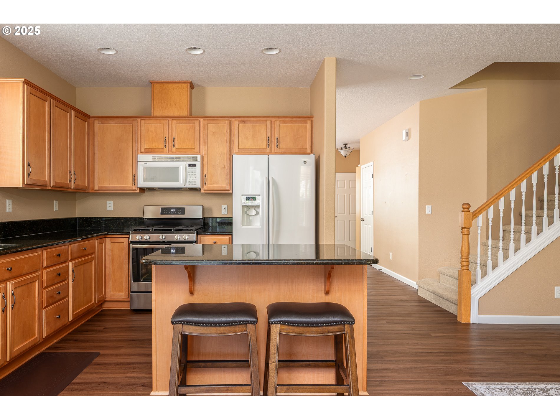 10636 Southwest 43rd Avenue Portland, OR 97219 - Photo 19 of 48 a kitchen with stainless steel appliances granite countertop a stove top oven a sink and a refrigerator