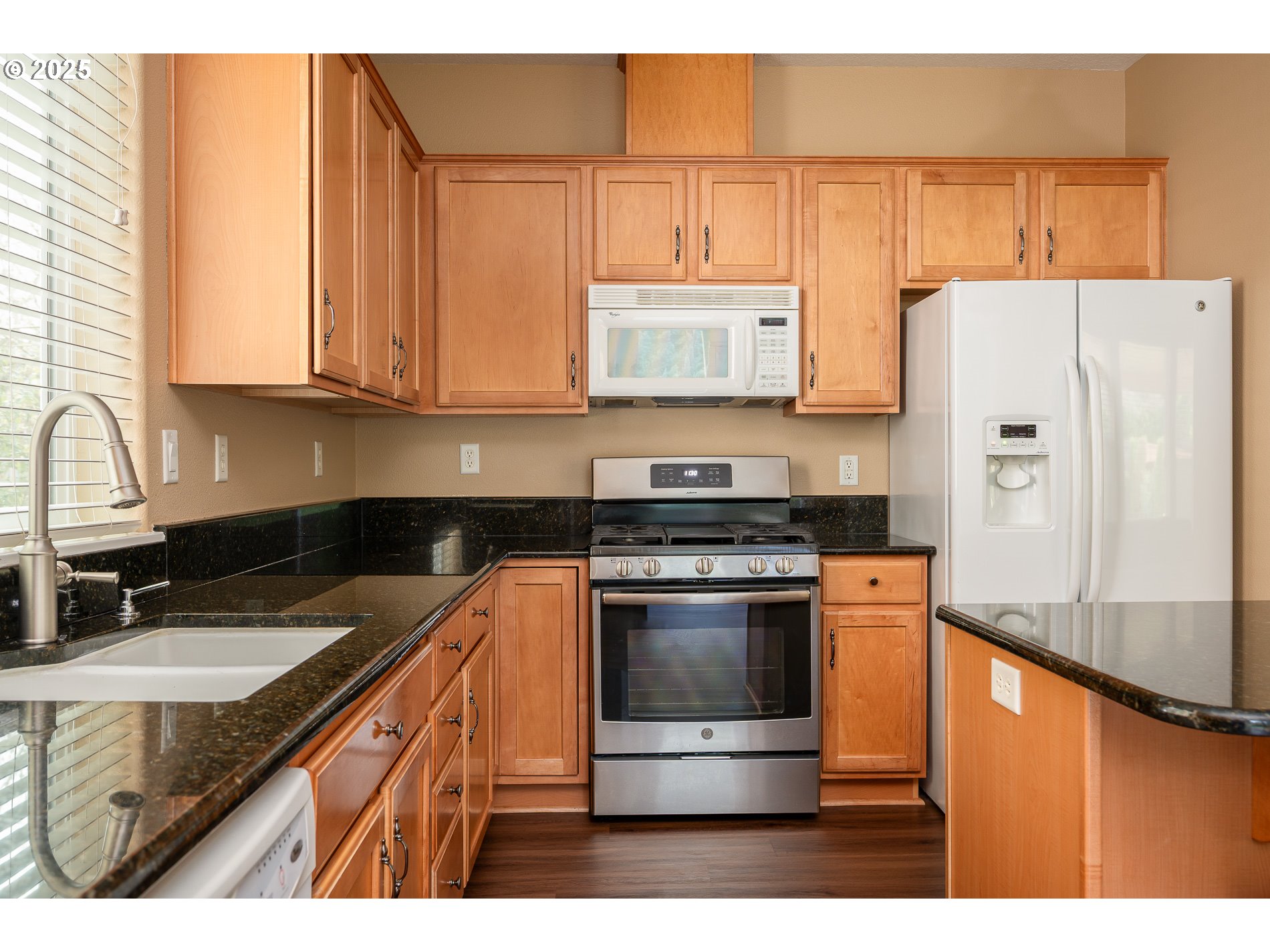 10636 Southwest 43rd Avenue Portland, OR 97219 - Photo 20 of 48 a kitchen with stainless steel appliances granite countertop a stove a sink and a refrigerator