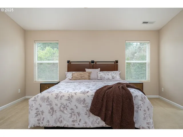 a bedroom with a bed and window