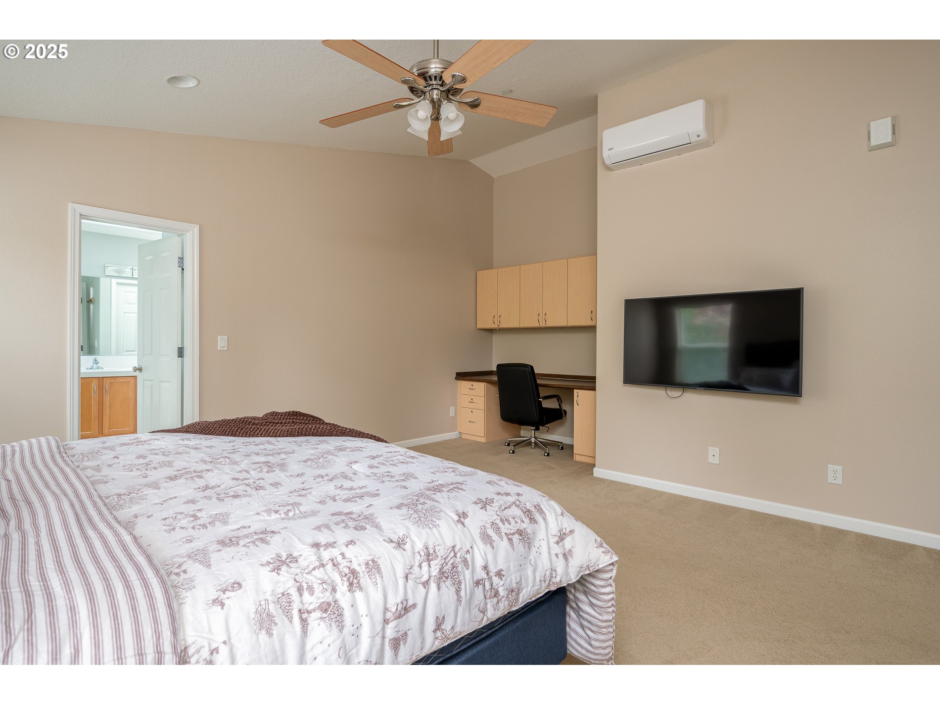 10636 Southwest 43rd Avenue Portland, OR 97219 - Photo 24 of 48 a bedroom with a bed and a flat screen tv