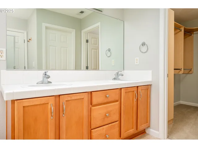 a bathroom with a sink double vanity and a mirror