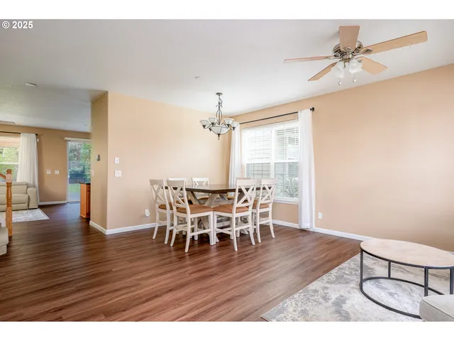 a dining room with furniture and wooden floor