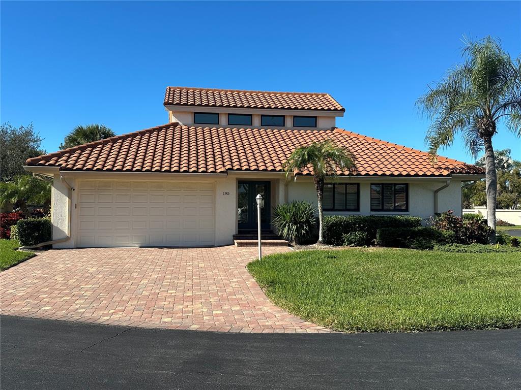 195 Inlets Boulevard, Unit 195 Nokomis, FL 34275 - Photo 1 of 48 a front view of a house with a garden