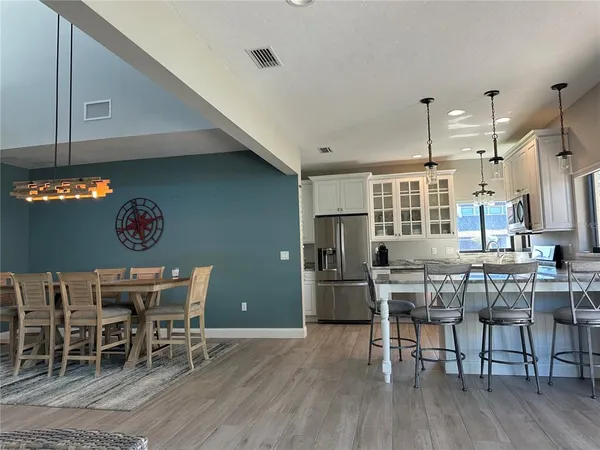 a view of a dining room with furniture and wooden floor