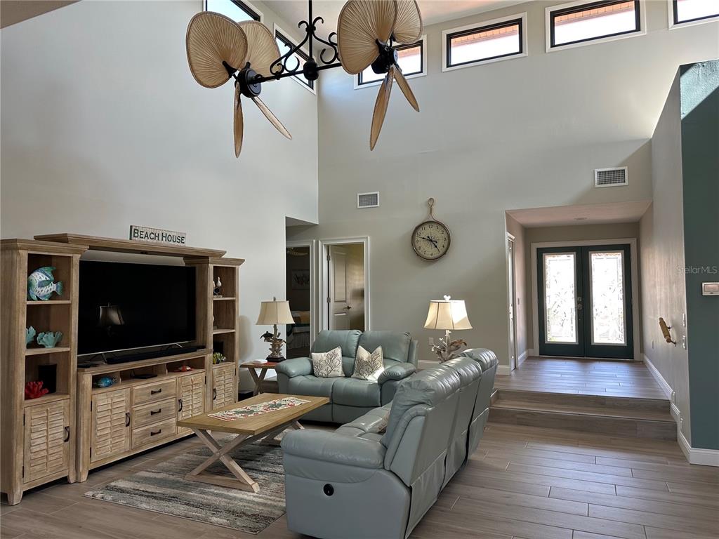 195 Inlets Boulevard, Unit 195 Nokomis, FL 34275 - Photo 22 of 48 a living room with furniture and a flat screen tv