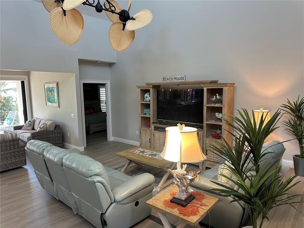 195 Inlets Boulevard, Unit 195 Nokomis, FL 34275 - Photo 23 of 48 a living room with furniture and a flat screen tv