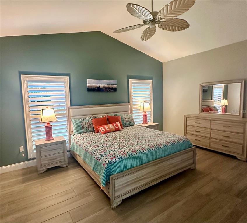 195 Inlets Boulevard, Unit 195 Nokomis, FL 34275 - Photo 27 of 48 a bedroom with a bed and a chandelier