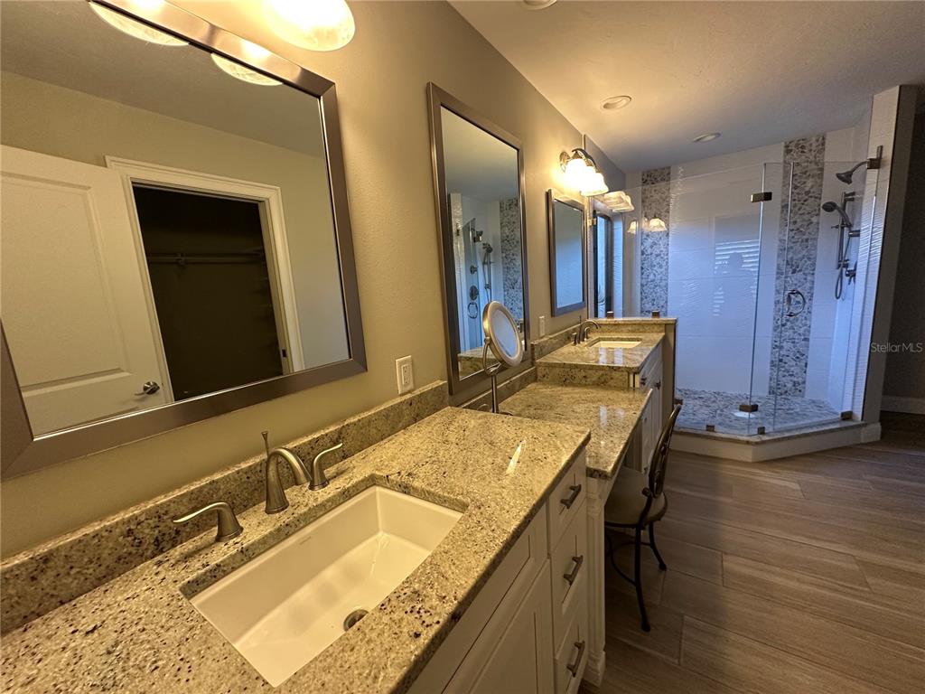 195 Inlets Boulevard, Unit 195 Nokomis, FL 34275 - Photo 28 of 48 a bathroom with a granite countertop sink and a mirror