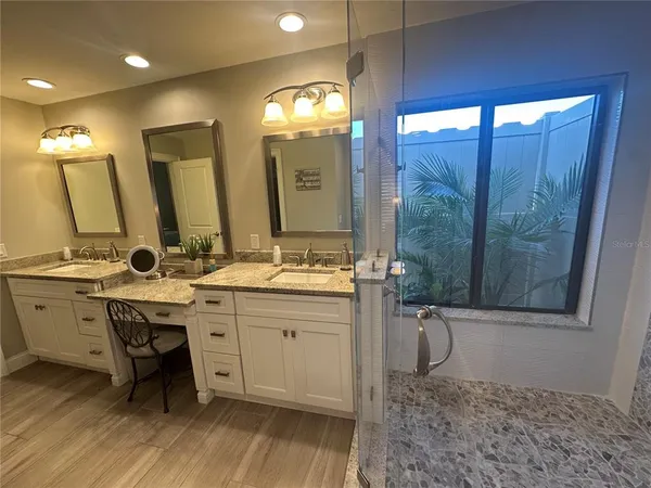 a bathroom with a window and a shower