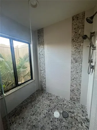 a spacious bathroom with double vanity and a mirror