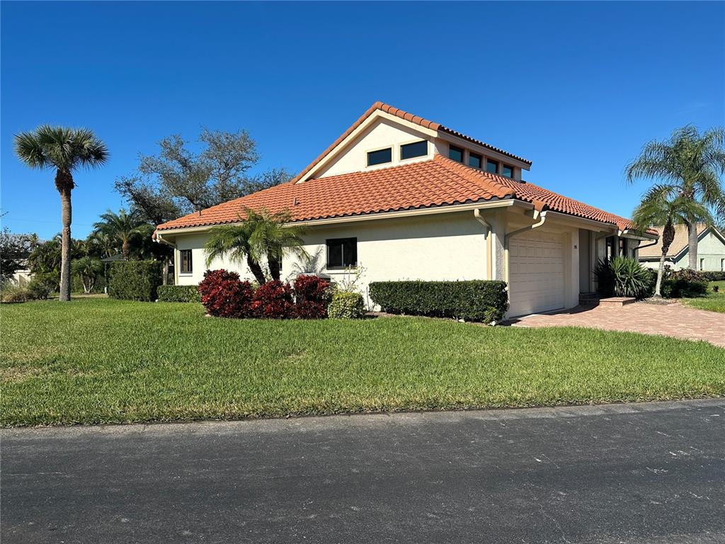 195 Inlets Boulevard, Unit 195 Nokomis, FL 34275 - Photo 3 of 48 a front view of a house with garden