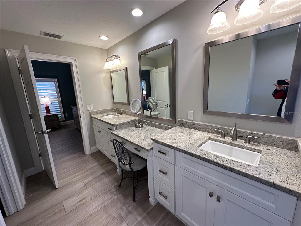 195 Inlets Boulevard, Unit 195 Nokomis, FL 34275 - Photo 31 of 48 a spacious bathroom with double vanity and a mirror