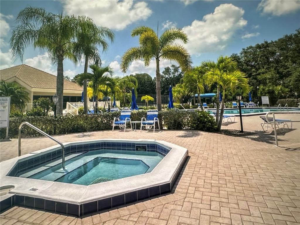 195 Inlets Boulevard, Unit 195 Nokomis, FL 34275 - Photo 39 of 48 a view of outdoor space with swimming pool and lounge chair