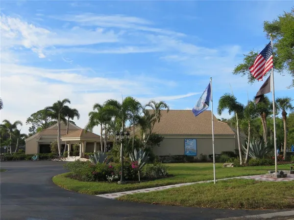 a front view of a house with a yard and a garden