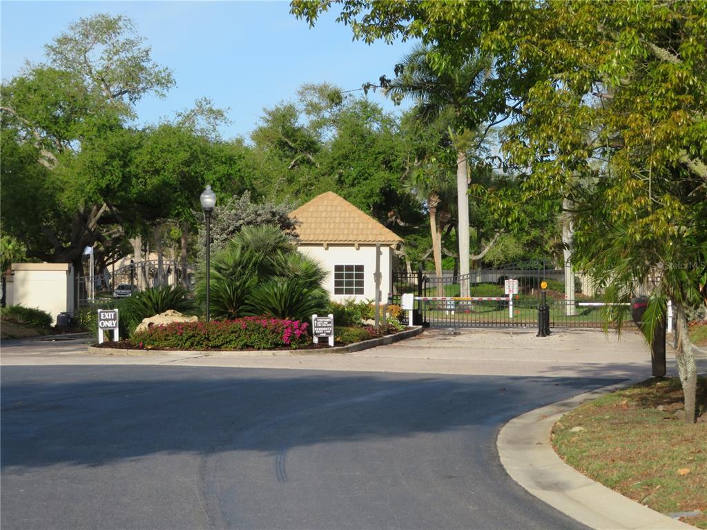 195 Inlets Boulevard, Unit 195 Nokomis, FL 34275 - Photo 43 of 48 a front view of a house with a yard and a garden