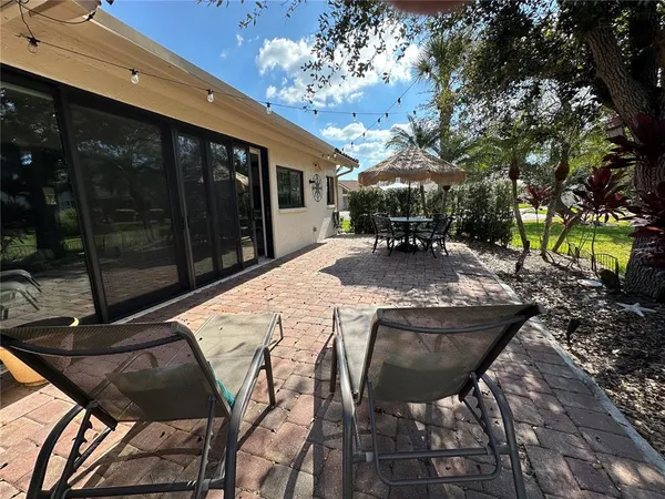 a view of a patio with table and chairs and potted plants